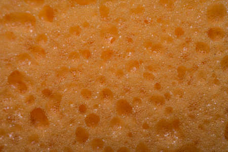 texture worn yellow sponge for washing dishes , close-up abstract background, macro photoの写真素材