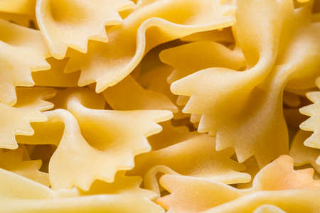 macaroni from hard wheat varieties in the form of a bow with zigzag edges. macro shooting. concept of a healthy lifestyle, proper nutritionの写真素材
