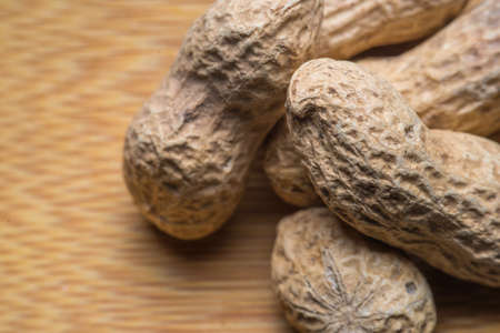 background of the peanuts with the shell not peeled - top view macroの写真素材