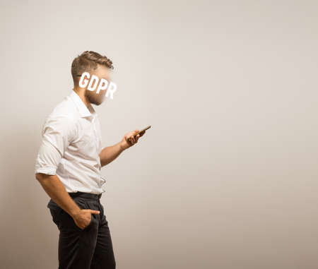 GDPR - a man hides his face with the inscription General rules for data protection. Cyber Security and Privacy. GDPRの写真素材
