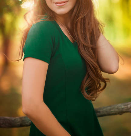 Beauty Romantic Girl Outdoors. Beautiful young brown hair model at park in Sun Light. Summer autum portrait. Glow Sun, Sunshine.の写真素材