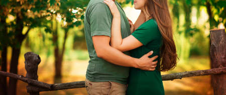 Happy young couple hugging and laughing outdoors. sunsetの写真素材