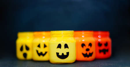 decorated halloween jars with cute grimaces, funny monsters happy halloweenの写真素材
