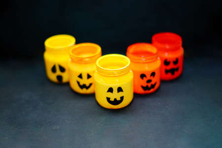 decorated halloween jars with cute grimaces, funny monsters happy halloweenの写真素材