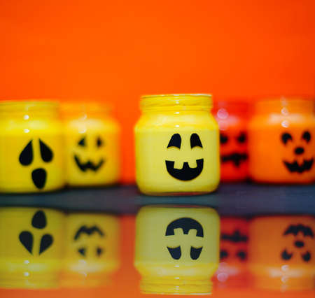 decorated halloween jars with cute grimaces, funny monsters happy halloweenの写真素材