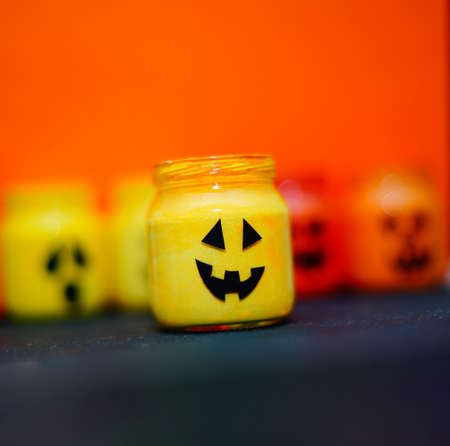 decorated halloween jars with cute grimaces, funny monsters happy halloweenの写真素材