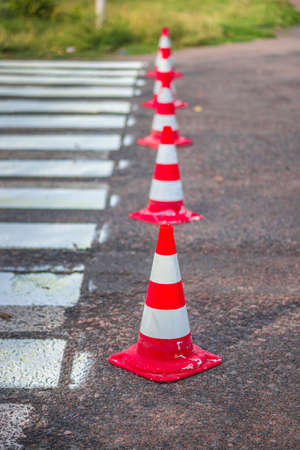 Road cones signal with two reflective stripes on the road with a pedestrian crossing. repair workの写真素材