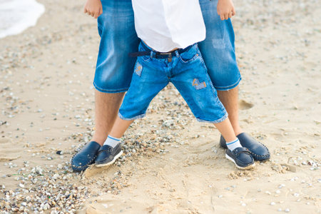 Father and son playing at beach together portrait fun happy lifestyle