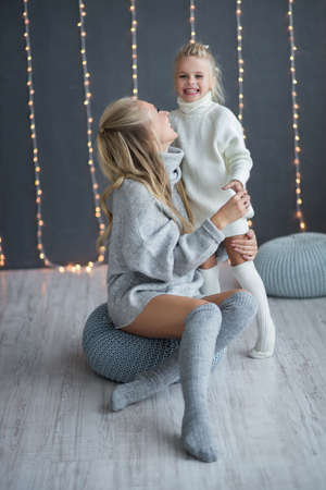 Happy loving family. mother and child girl playing, kissing and huggingの写真素材