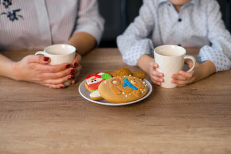 Mother and son in the kitchen with pastries. Studio shot, home interior.の写真素材