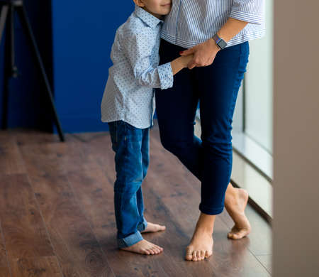 Mother hugging and kissing her baby sonの写真素材