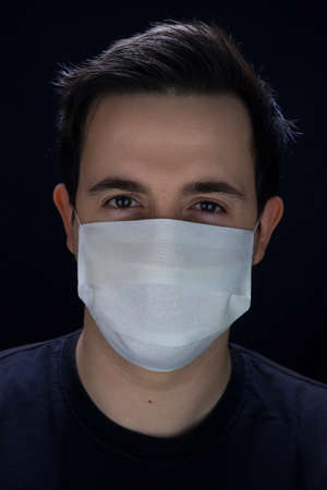 Man in a white medical mask for protection Covid-19の写真素材