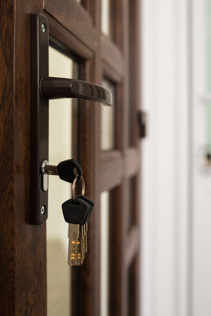 door lock with keychain, open door. Door with keys.