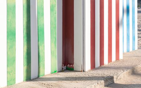 Colorful wooden beach huts. White,red, green and other color stripes.の写真素材
