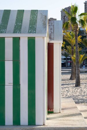 Colorful wooden beach huts. White,red, green and other color stripes.の写真素材