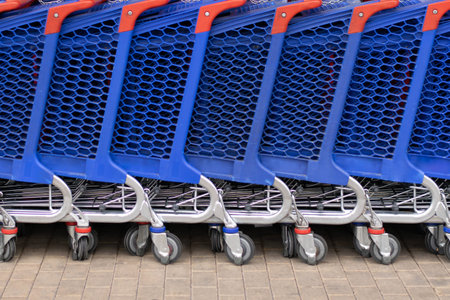 Shooping trolley row. Blue carts supermarket.