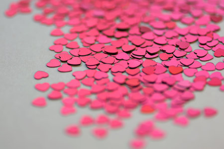 Red and pink glitter hearts on white background. Selective focus. ValentineÂ´s Day.