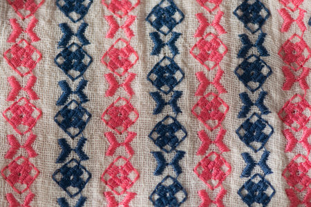 Embroidered pattern on cotton fabric. Fragment. Handmade.