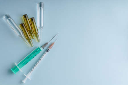 Syringe and ampoule on blueの写真素材
