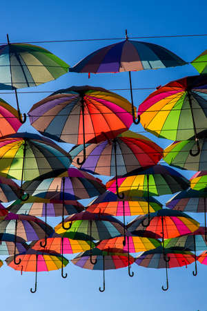 Colorful umbrellas background, against the sky. Street decoration, nodody. Vertical photo.の写真素材