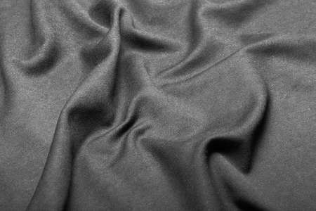 Texture of black fabric put by waves, isolated on white background nobody.の写真素材