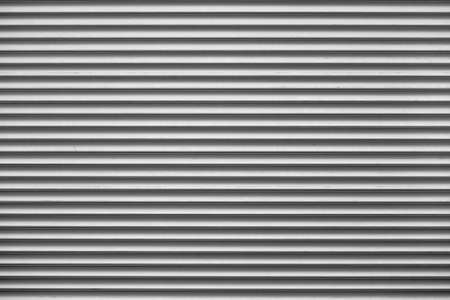 Garage rolling shutters, horizontal rolleta of white color close up.の写真素材