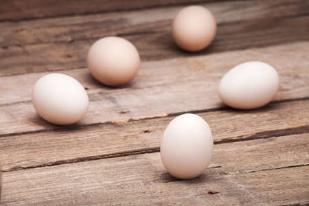 The eggs scattered on a wooden table from old boards, nobody.の写真素材