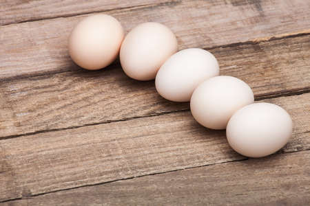 The eggs, the top view which are laid out in a row on a wooden table from old boards, nobody.の写真素材