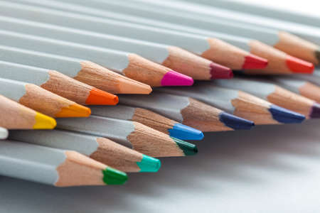 several colored pencils which are looking out of a pack which are on the sheet of paper.の写真素材