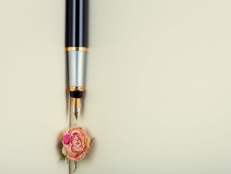 the ink handle lies on empty pages of a notebook with blank sheets, a fountain pen from a book with rose.の写真素材