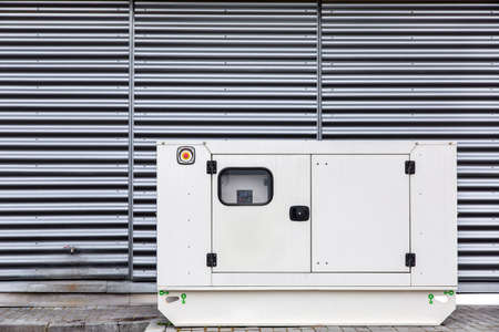 Mobile electric power generator for emergency situations, white color on outdoor.の写真素材