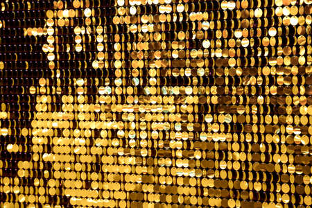 Sequins of gold color, round shining close up.の写真素材