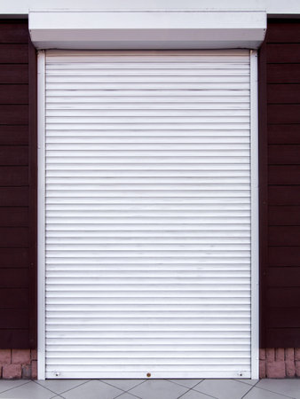 Rollet metal white color, the buildings closed a dverina a facade an entrance to the house decorated...