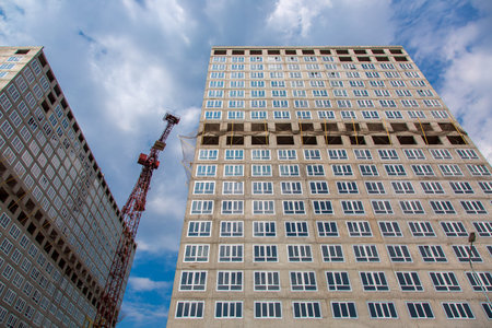 the multystoried building under construction with the established double-glazed windows.
