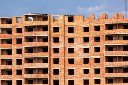 the multystoried building under construction from a red brick.