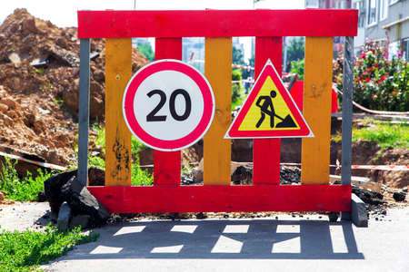 Protections an obstacle with information signs about repair work about restriction of speed.の写真素材
