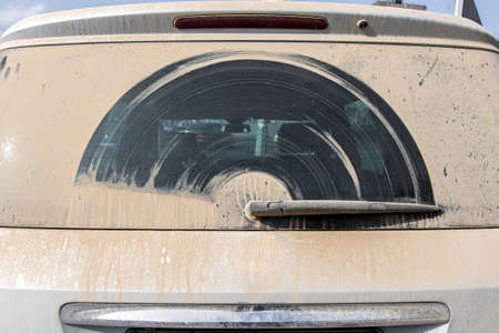 Dirty car in dust view of windscreen of a back view.の写真素材