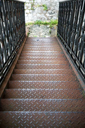 metal fire escape, view from the top to the bottom on the steps of the outer iron staircase.の写真素材