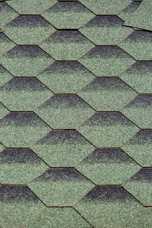 Bitumen shingles of green gray color, close-up of shingles.