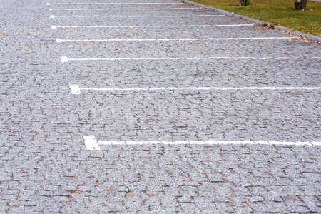 empty parking for cars with free lots outdoors in the park area of the city, close up side view.の写真素材