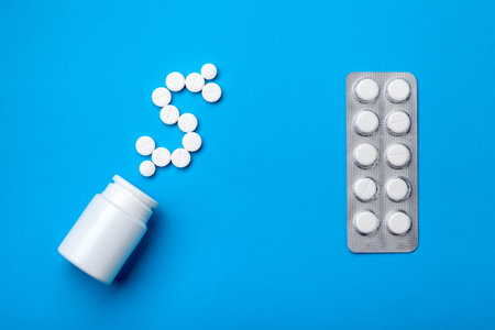 Blister with a treating drug next to a bottle for pills and a dollar sign from pills as a symbol of...