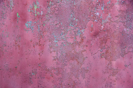 Texture of metal with old paint in red color, close-up.