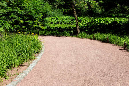granite walkway for walking in the park with flowers and trees, nobody close-up.の写真素材