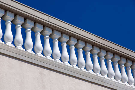 white stone balustrades over the wall architecture of the Baroque against the blue sky on a sunny day.の写真素材
