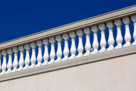 white balustrades with stone railing in gray against a blue sky, details of architecture in the Italian style.の写真素材
