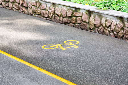Bicycle symbol on an asphalt road, close up nobody.の写真素材