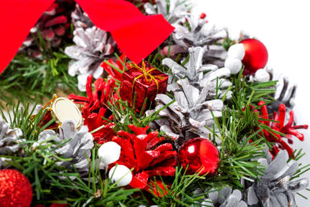 Christmas wreath with colored cones in gray and red and Christmas tree decorations in the form of a gift box, close up details of holiday decorations.の写真素材