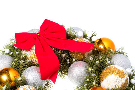 Christmas wreath postcard with red bow and christmas toys balls made of beads Isolated on a white background.の写真素材