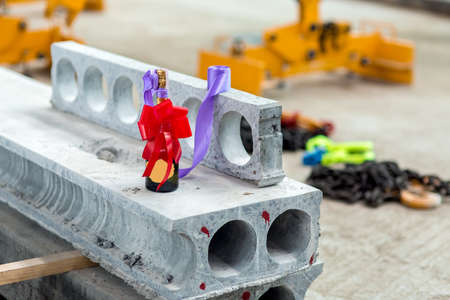 a bottle of champagne with a red ribbon bow for the grand opening of the plant for the production of hollow core slabs.の写真素材