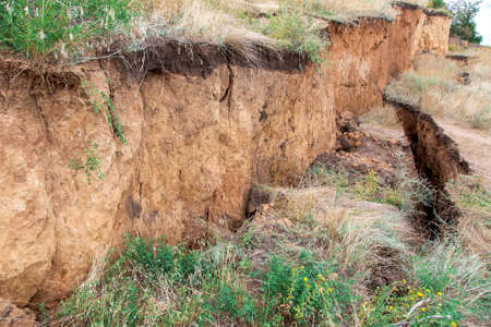 ecological disaster landslide of clay soil after an earthquake, a close up of earth cracks.の写真素材